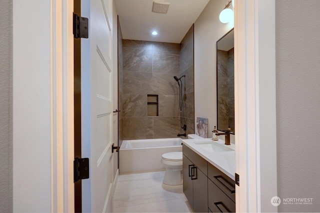 full bathroom featuring tile patterned floors, vanity, toilet, and tiled shower / bath