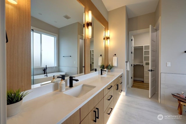 bathroom featuring a bathtub, hardwood / wood-style floors, and vanity