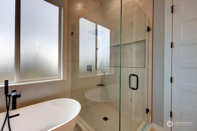 bathroom with shower with separate bathtub