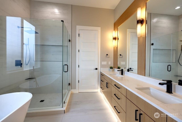 bathroom with vanity and independent shower and bath