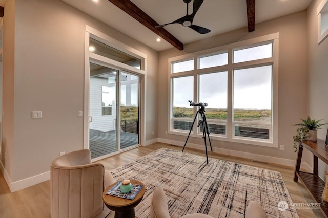 sunroom / solarium with beam ceiling and ceiling fan