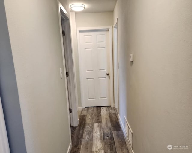 hallway with dark wood-type flooring