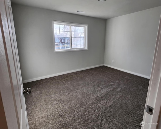 empty room with dark colored carpet