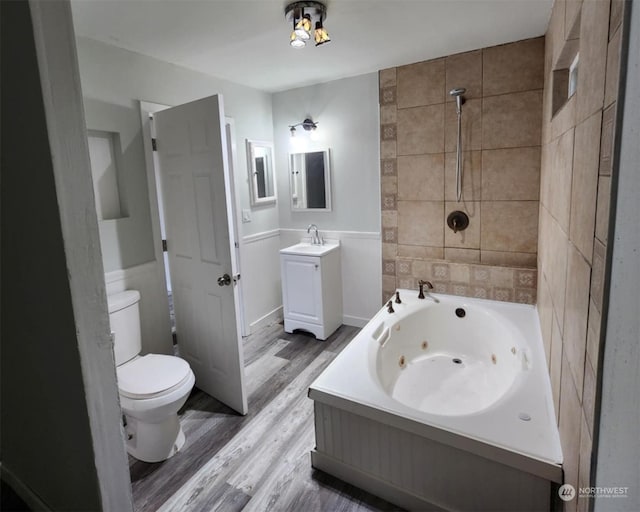 full bathroom featuring wood-type flooring, vanity, shower with separate bathtub, and toilet