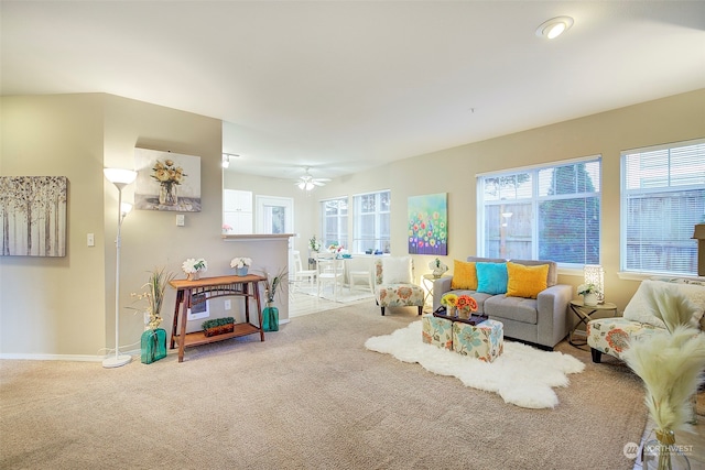 carpeted living room featuring ceiling fan