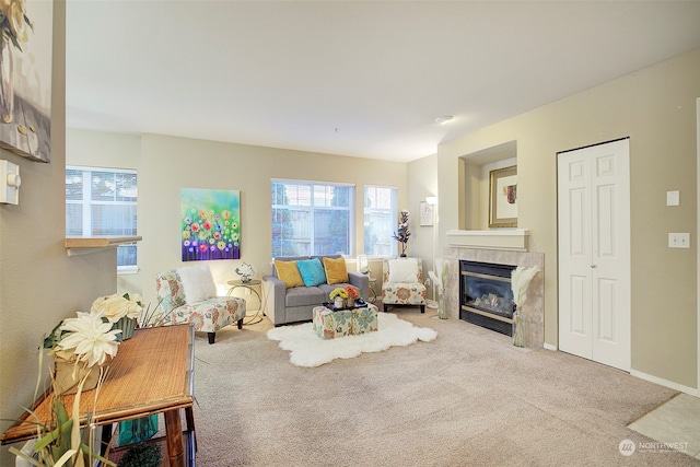 carpeted living room with a tile fireplace and a healthy amount of sunlight