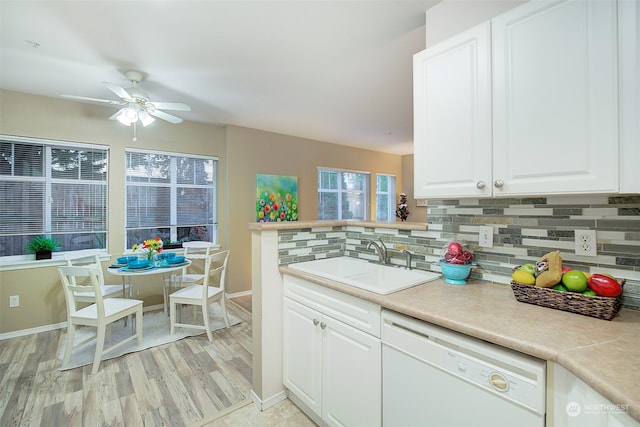 kitchen with dishwasher, white cabinets, light hardwood / wood-style floors, and sink