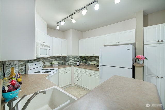 kitchen with backsplash, white cabinetry, sink, and white appliances