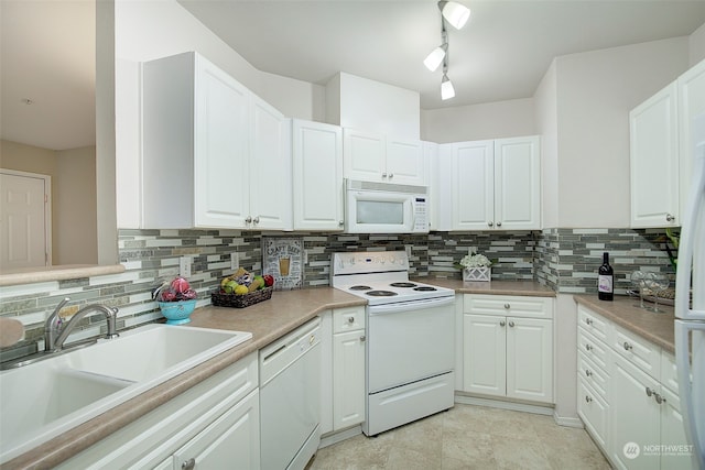 kitchen with backsplash, white cabinetry, white appliances, and sink