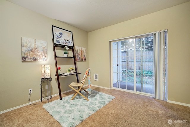 living area featuring light carpet