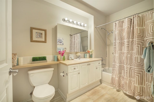 full bathroom featuring tile patterned floors, vanity, shower / bath combination with curtain, and toilet