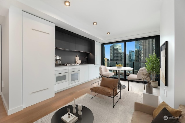 living room with sink and light hardwood / wood-style floors