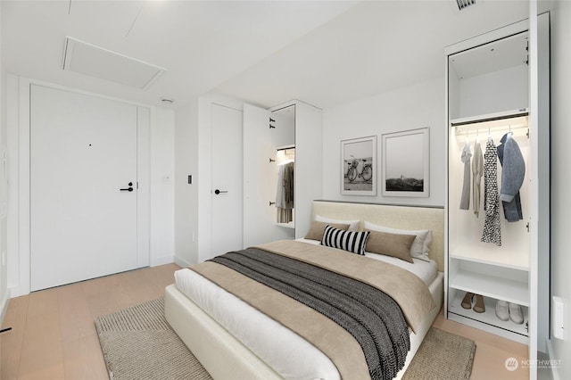 bedroom featuring light hardwood / wood-style floors and a closet