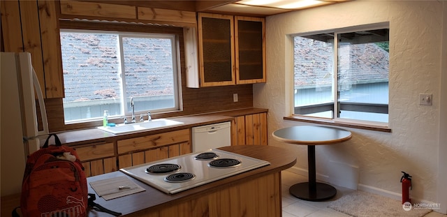 kitchen featuring sink, white appliances, and light tile patterned flooring