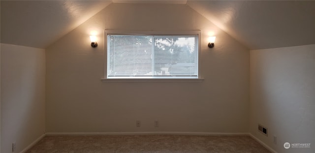 bonus room with carpet floors and vaulted ceiling