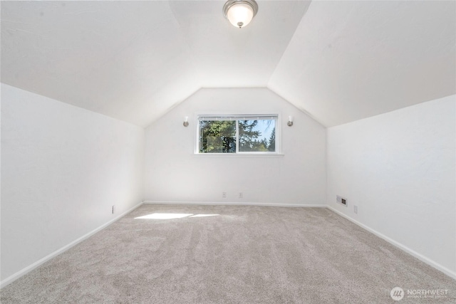 bonus room with carpet floors, baseboards, and lofted ceiling