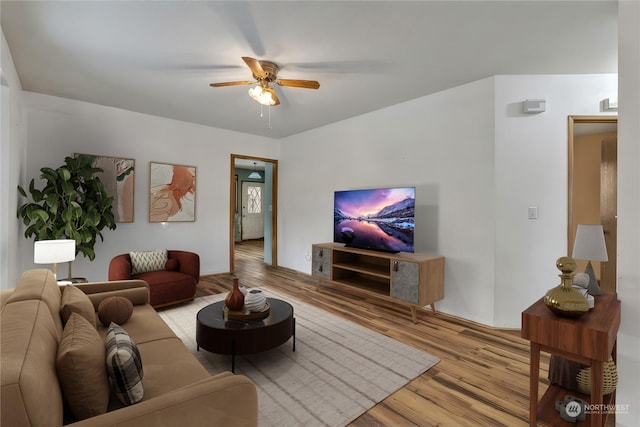 living room featuring ceiling fan and light wood-type flooring