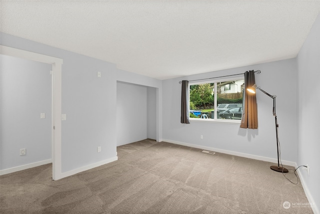 empty room with light colored carpet