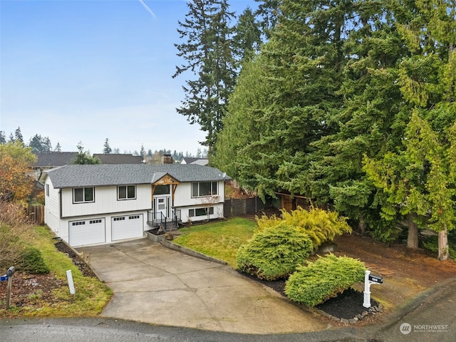 split foyer home featuring a garage and a front yard