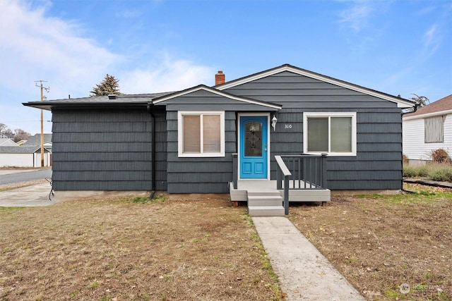 310 W 3rd Ave, Ritzville, WA 99169 - view of front of house featuring a chimney and a front yard