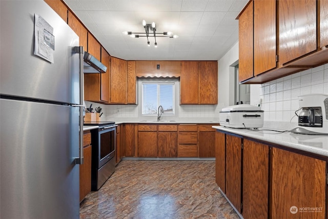 310 W 3rd Ave, Ritzville, WA 99169 - kitchen with appliances with stainless steel finishes, a sink, brown cabinets, extractor fan, and tasteful backsplash