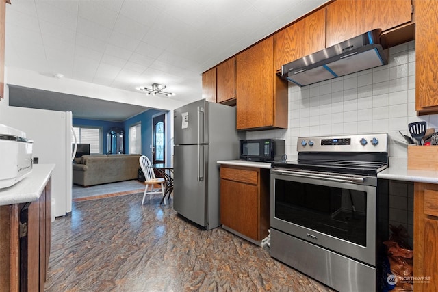 310 W 3rd Ave, Ritzville, WA 99169 - kitchen with appliances with stainless steel finishes, ventilation hood, brown cabinetry, and light countertops
