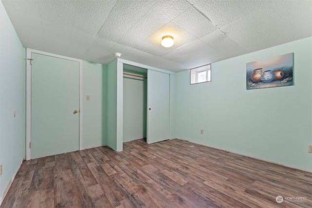 unfurnished bedroom featuring a closet and dark hardwood / wood-style floors