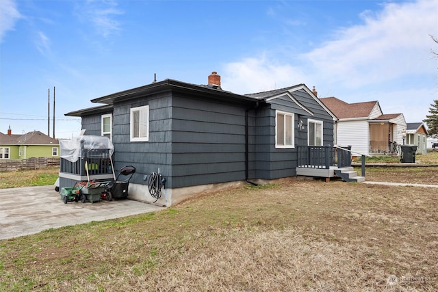 view of home's exterior with a patio area and a yard