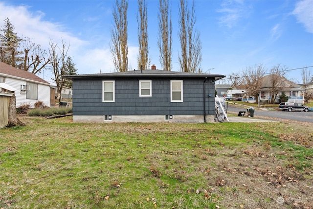 view of side of home with a lawn