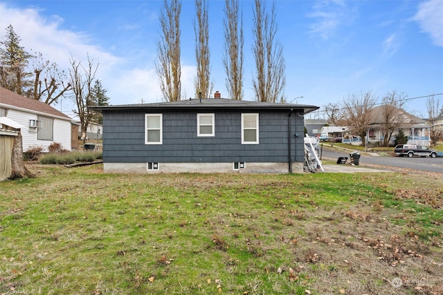 310 W 3rd Ave, Ritzville, WA 99169 - view of side of home featuring a chimney and a yard