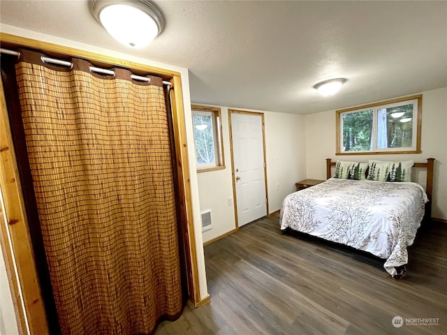 2820 State Route 105, Grayland, WA 98547 - bedroom with wood finished floors, a textured ceiling, and baseboards