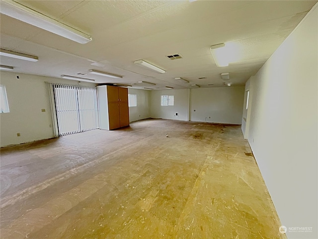 unfurnished room with visible vents