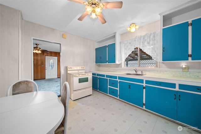 kitchen with white range with electric stovetop, blue cabinetry, ceiling fan, and sink