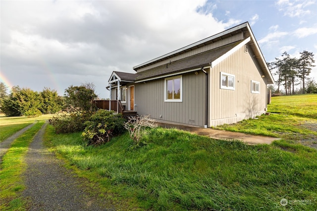 view of side of home with a lawn