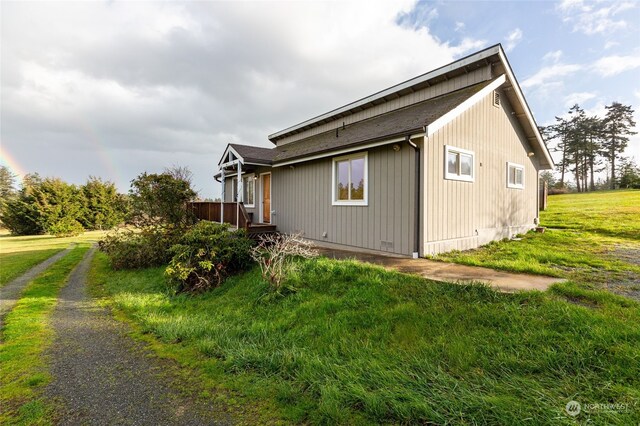 view of property exterior with a yard