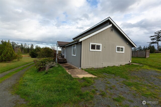 view of side of property with a lawn