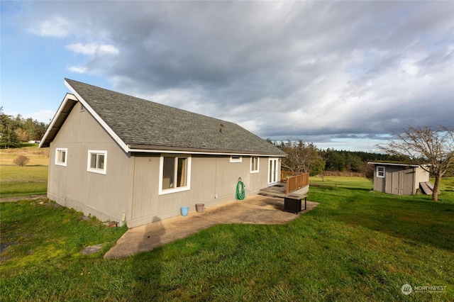 rear view of house featuring a patio, a storage shed, and a lawn