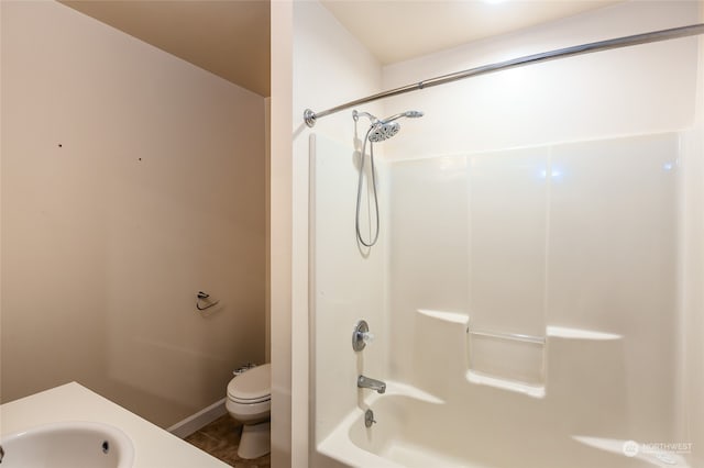 full bathroom featuring toilet, tub / shower combination, and sink