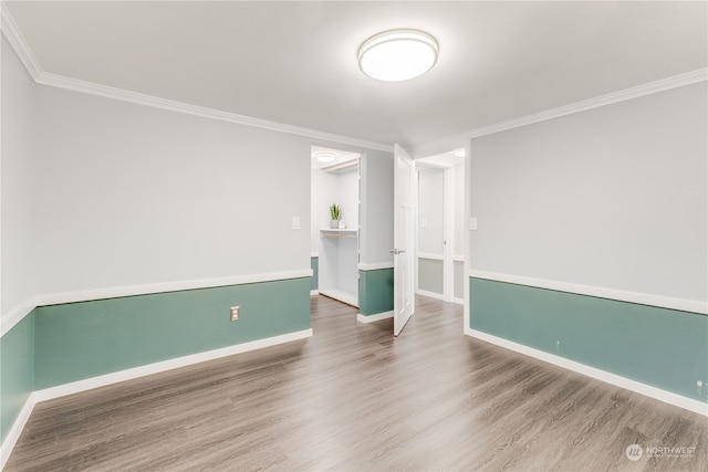 unfurnished room featuring crown molding and hardwood / wood-style floors