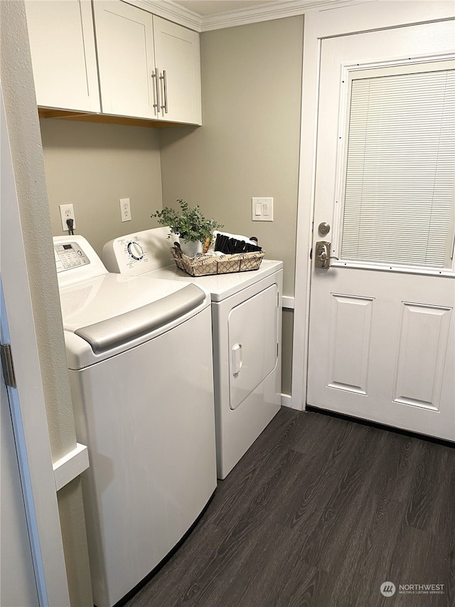 clothes washing area featuring cabinets, dark hardwood / wood-style floors, washer and clothes dryer, and crown molding