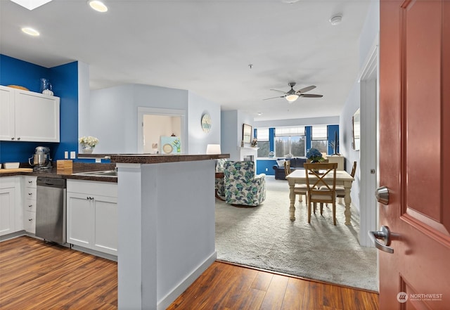 kitchen featuring dishwasher, kitchen peninsula, dark hardwood / wood-style floors, ceiling fan, and white cabinetry