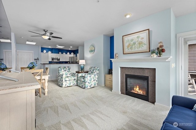 carpeted living room with ceiling fan