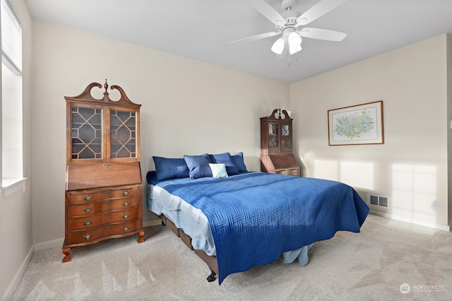 bedroom with ceiling fan and light carpet