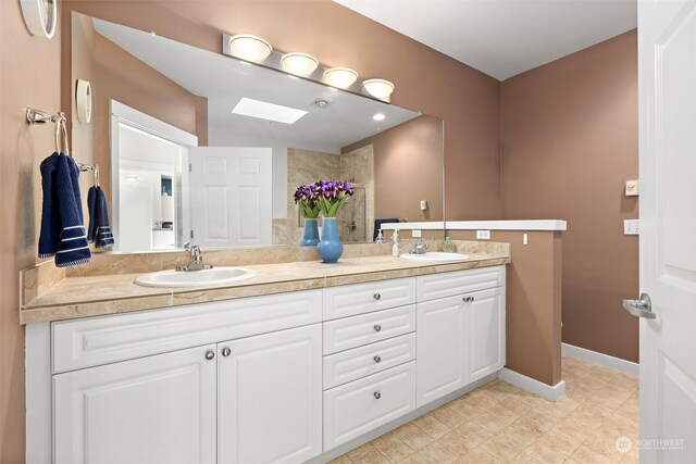 bathroom with a shower and vanity