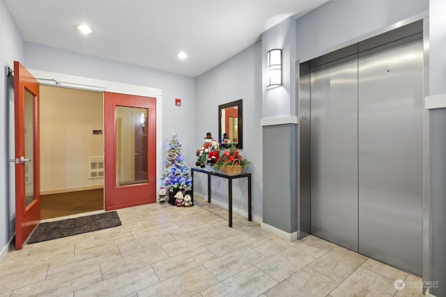 hallway featuring french doors, elevator, and heating unit