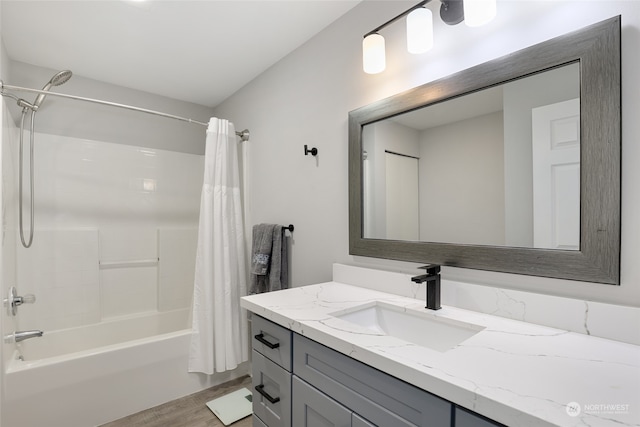 bathroom featuring vanity, wood-type flooring, and shower / tub combo