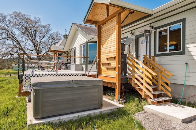 wooden terrace featuring a hot tub