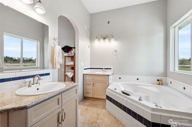 bathroom with tile patterned flooring, vanity, and plenty of natural light