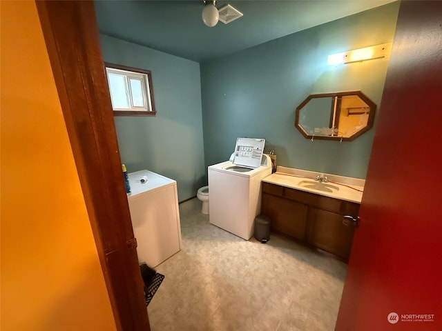 bathroom with vanity, separate washer and dryer, and toilet