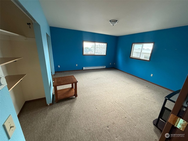 unfurnished bedroom featuring carpet flooring and baseboard heating